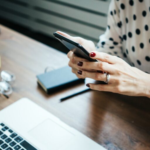 Woman,Working,With,Laptop,And,Mobile,Phone,In,Hands,At